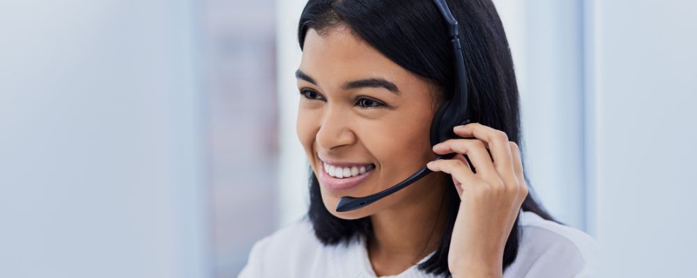 Woman smiling on the phone, representing good connection and call quality.